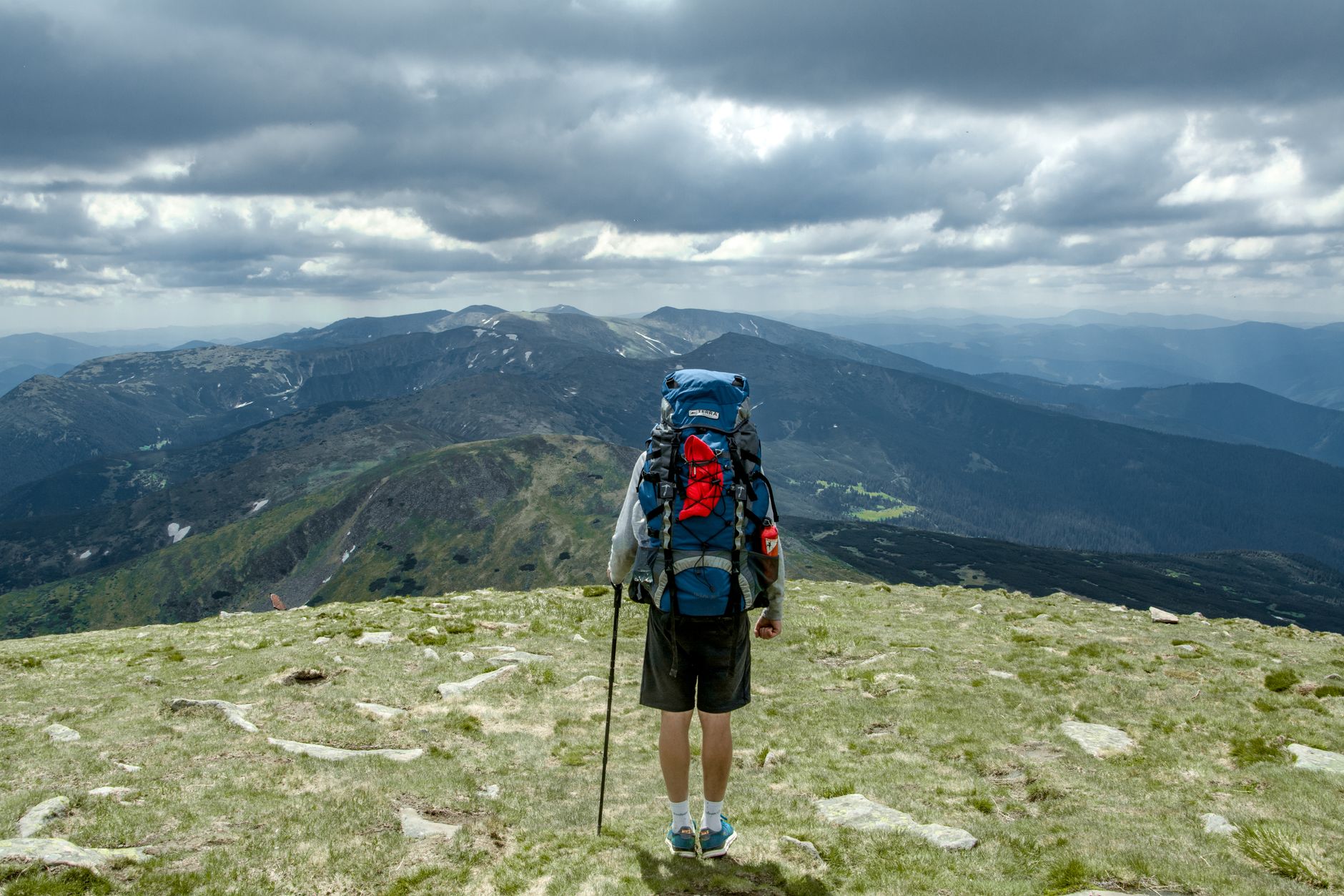 Góry Rumunii czy Ukrainy porównanie szlaków cen dojazdu i infrastruktury dla miłośników trekkingu Trekker z plecakiem na górze Howerla w Ukrainie przy pochmurnym niebie